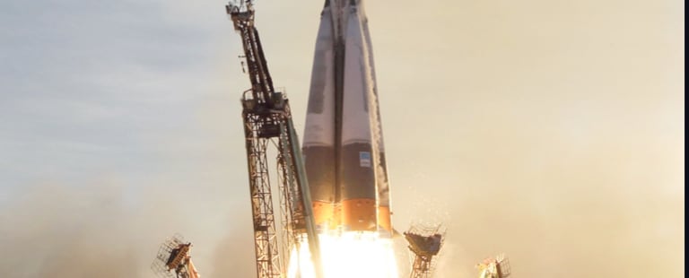 Spaceship lifting off from a launchpad.